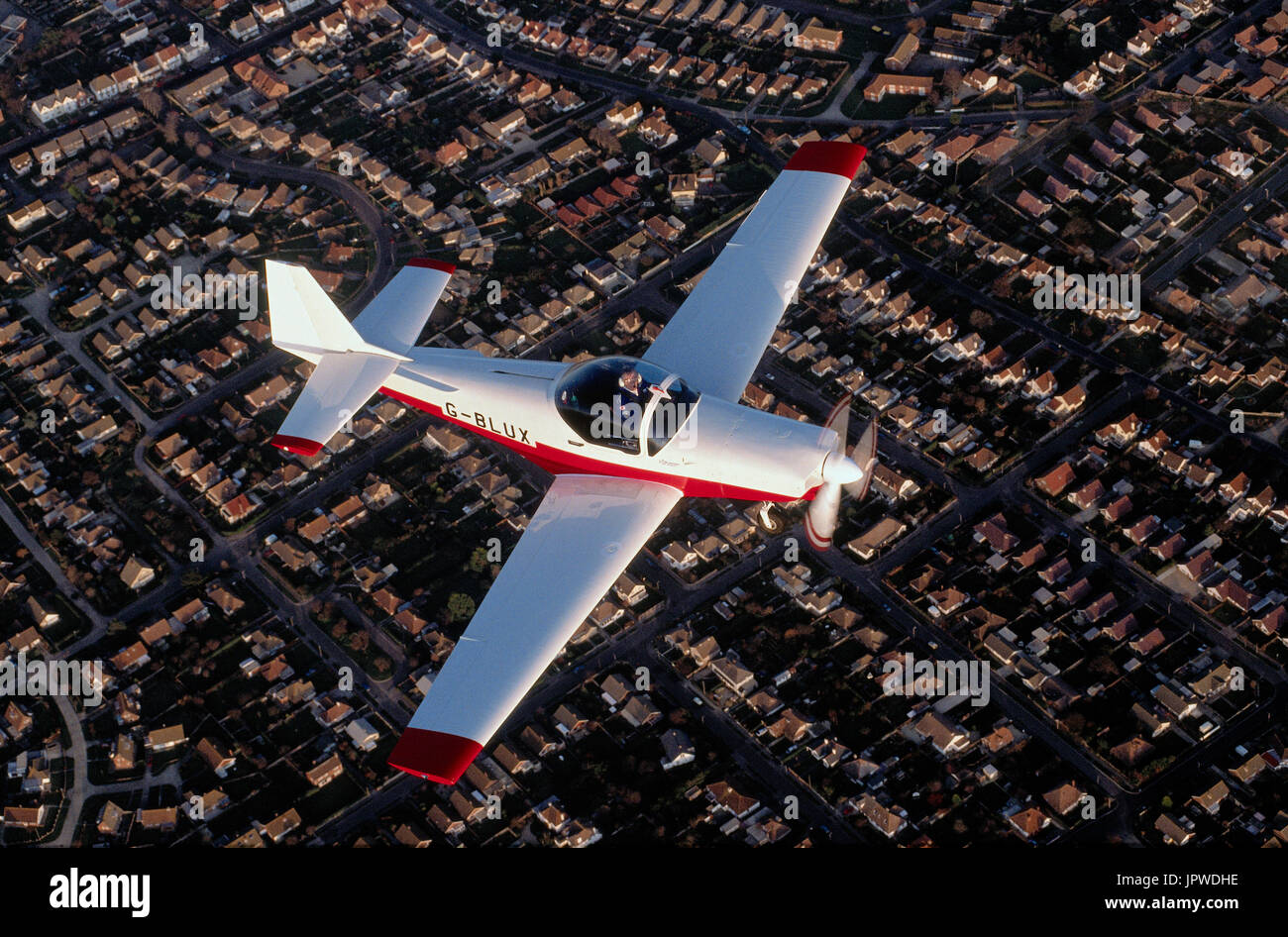 Slingsby T-67 Firefly wearing B class test registration flying over houses Stock Photo