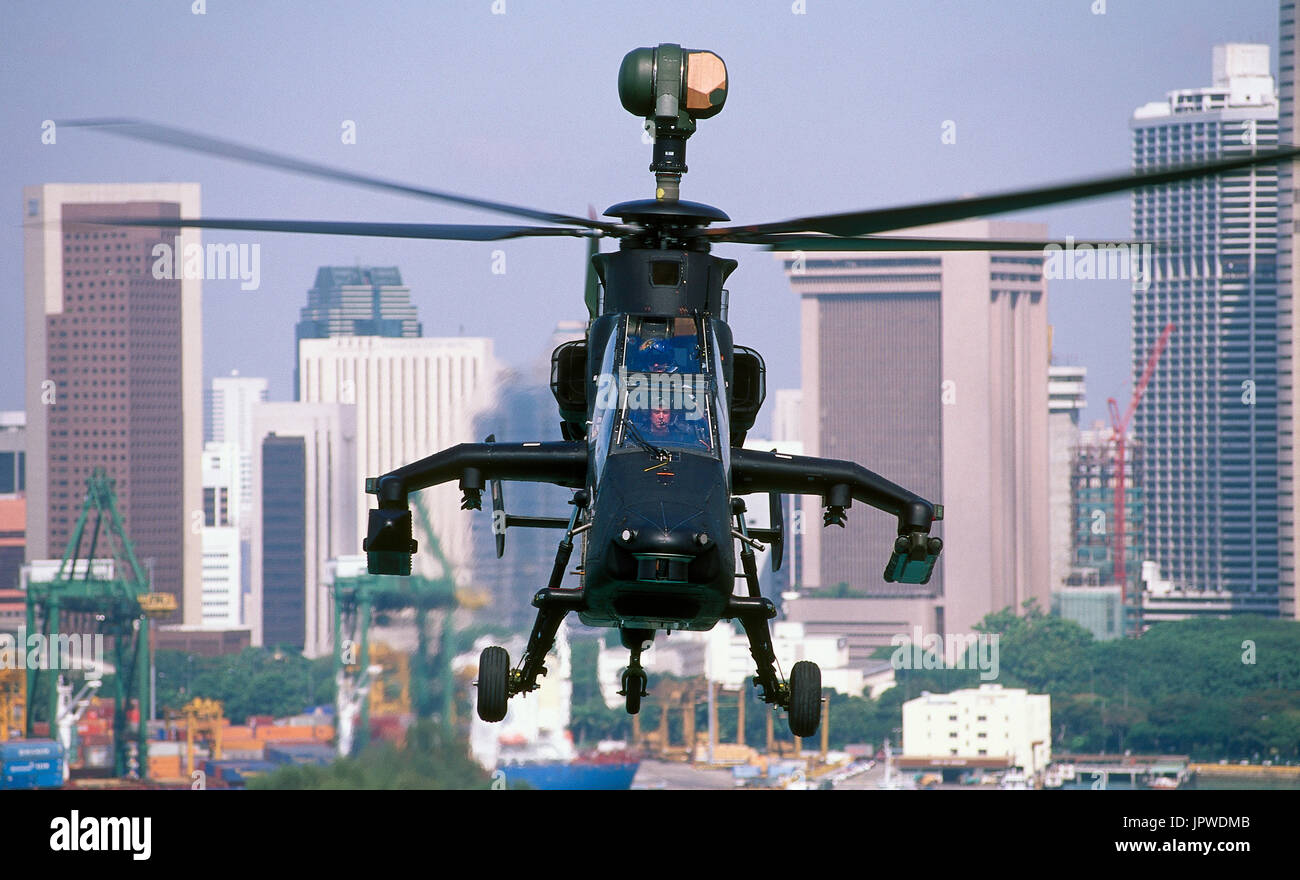 Eurocopter Tigre prototype flying with Singapore skyscrapers behind Stock Photo