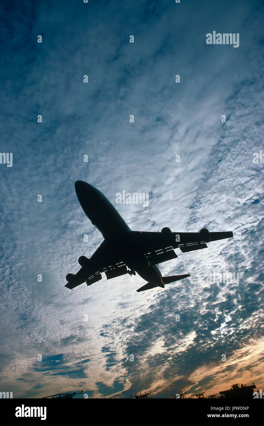Boeing 747-200 on final-approach at dusk with alto-cumulus clouds ...