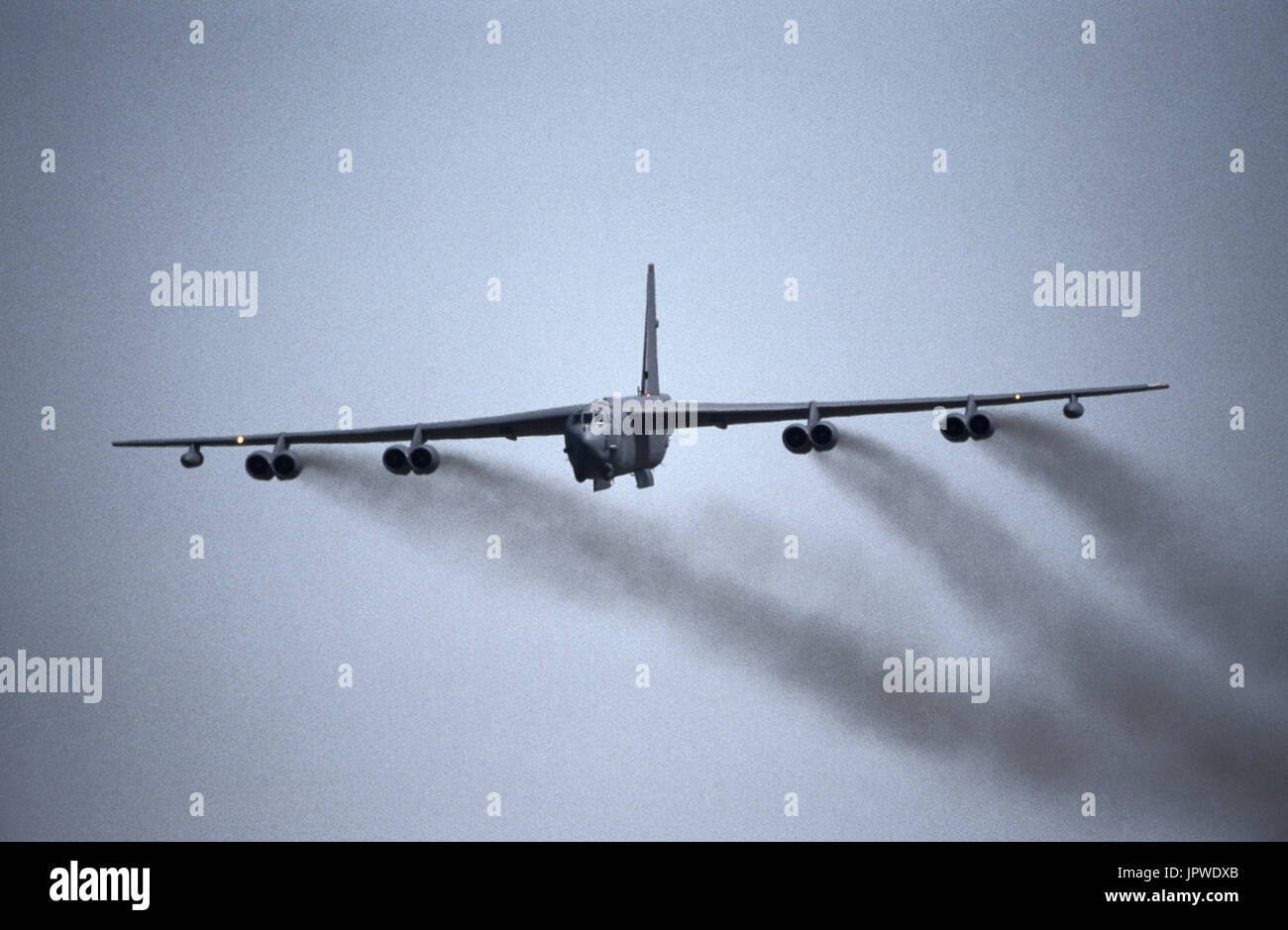 USAF Boeing B-52 Stratofortress with black smoke from engines after take-off and undercarriage retracting Stock Photo