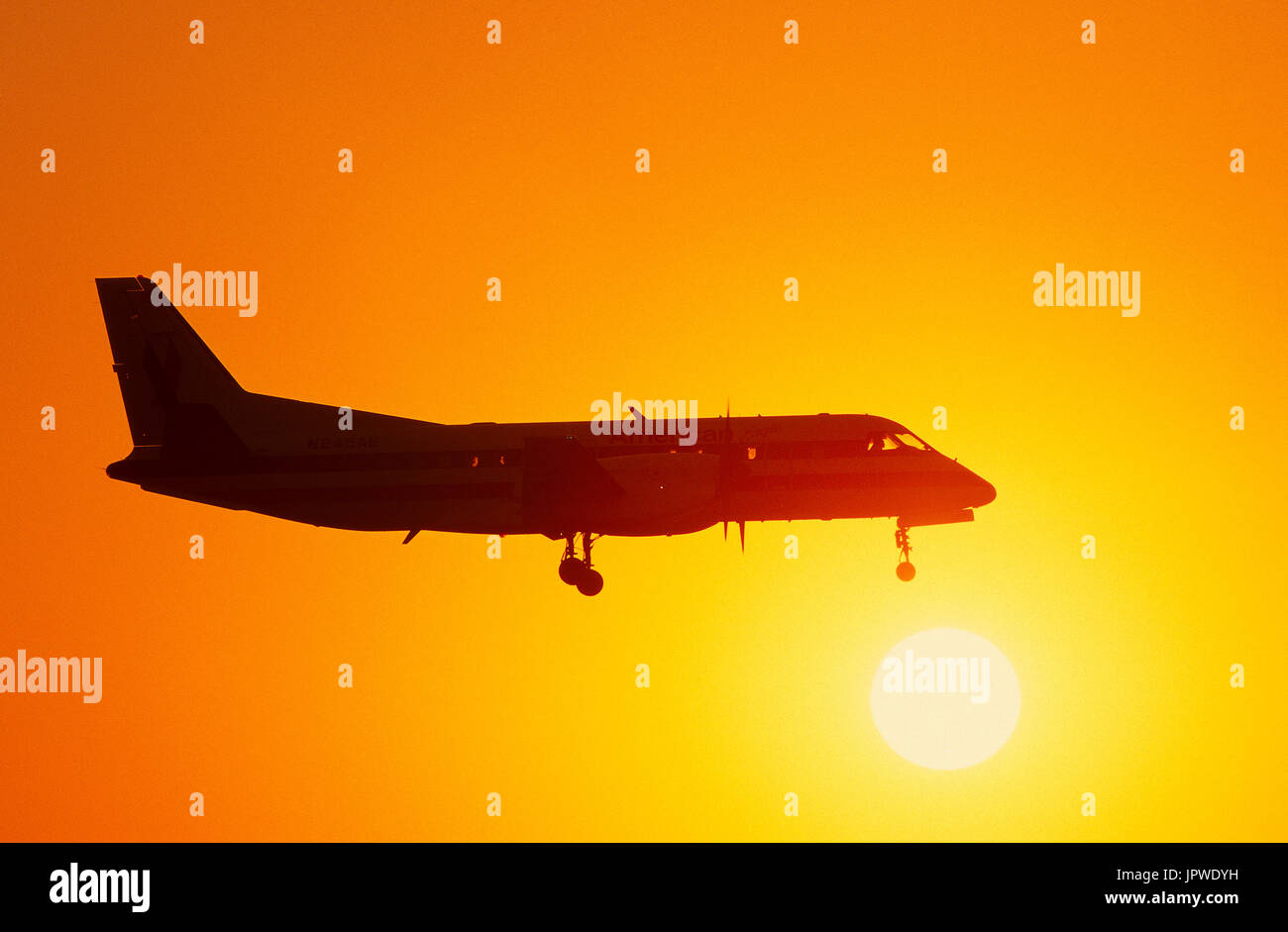 Saab SF-340B on final-approach at dusk Stock Photo