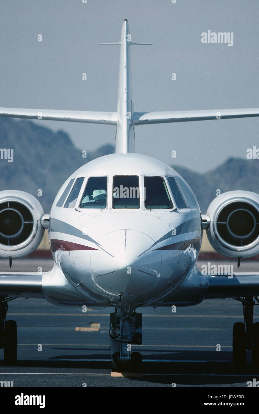 nose and tail-fin of a Dassault Falcon 20 parked Stock Photo