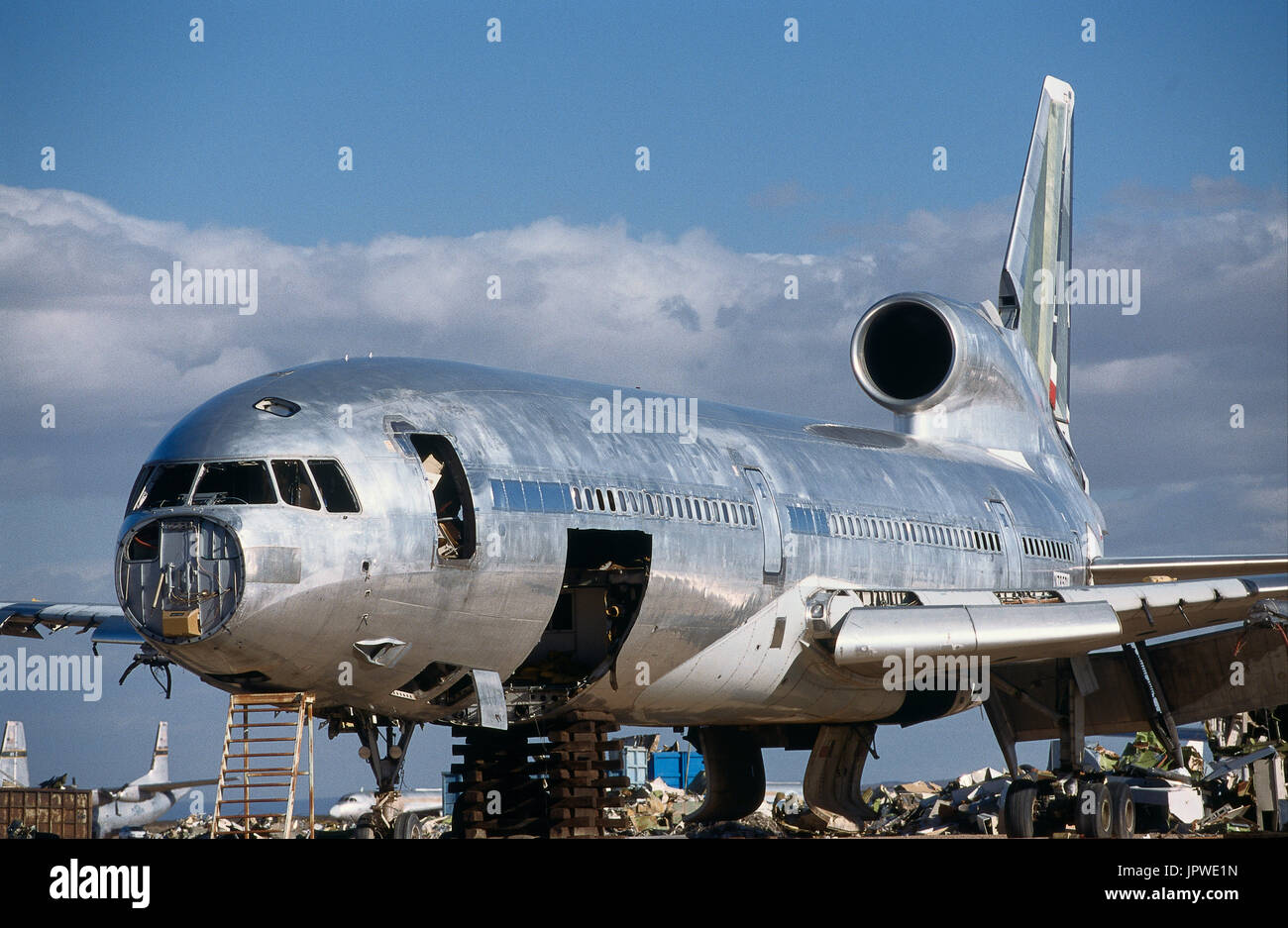 ex Delta Air Lines Lockheed L-1011 Tristar in bare metal finish being parted-out in the desert with Eastern Airlines titles visible on the fuselage an Stock Photo