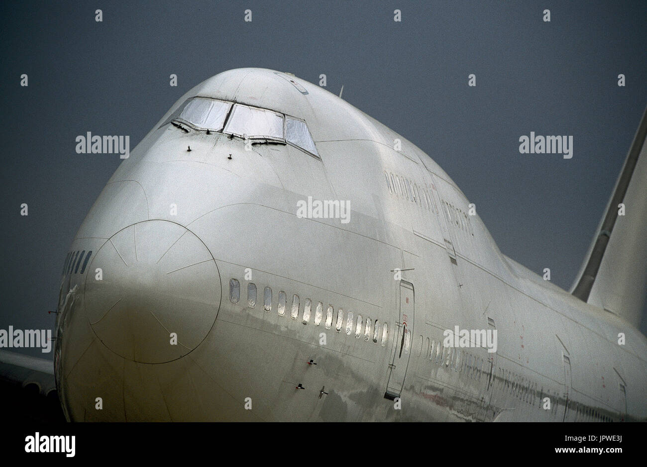 desert-storage of a white livery Boeing 747-300 parked with all logos removed and silver foil protective-covers over the windows due to the economic r Stock Photo