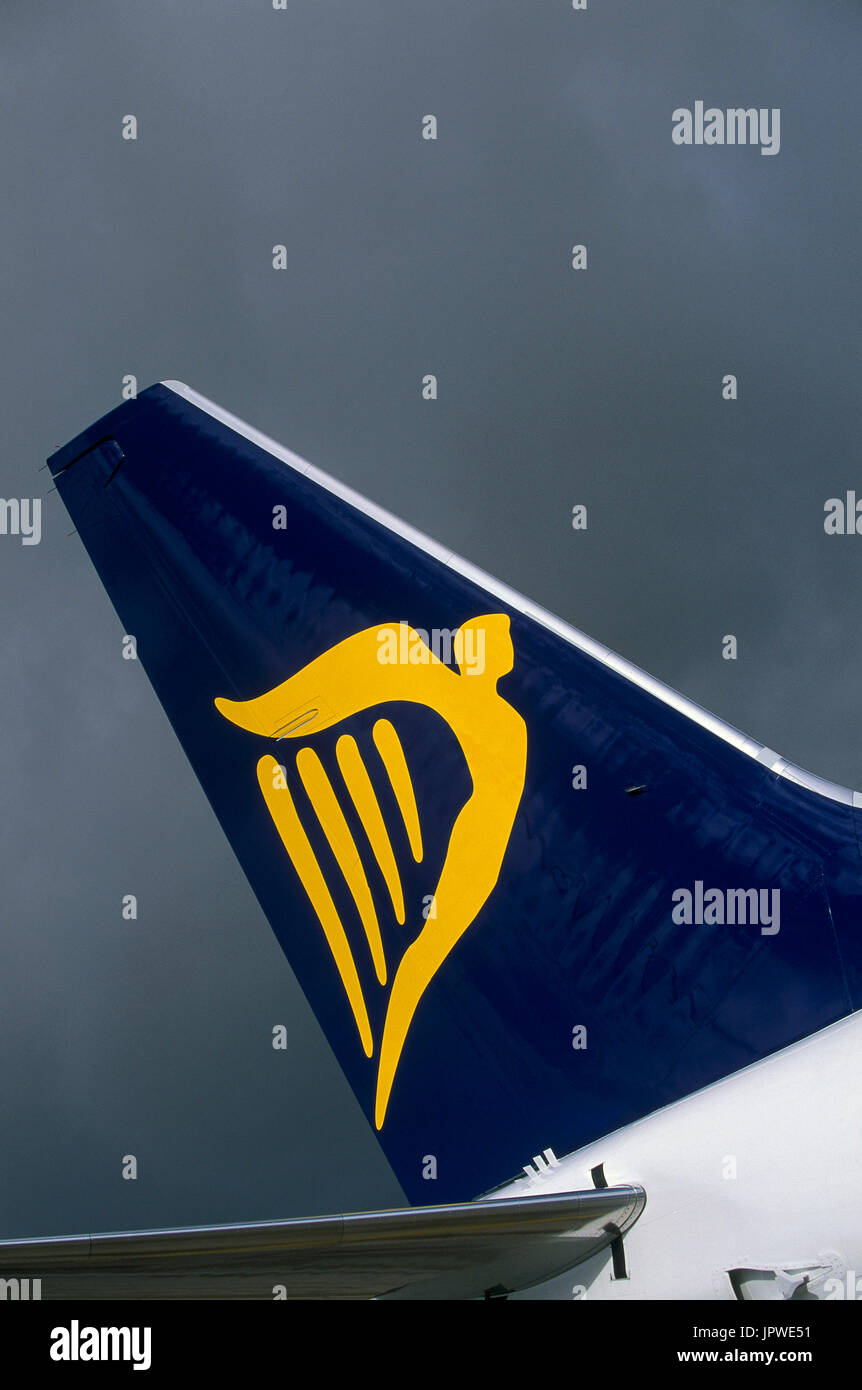 tail-fin with logo of a Ryanair Boeing 737-800 against a dark cloudy sky Stock Photo