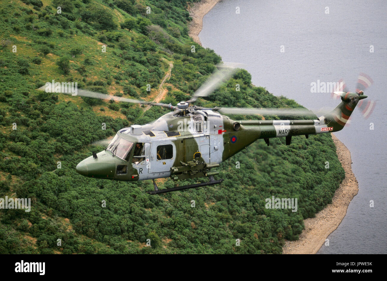 UK Royal Marines Westland Lynx AH-7 low-flying over a lake on Dartmoor, Devon, UK Stock Photo