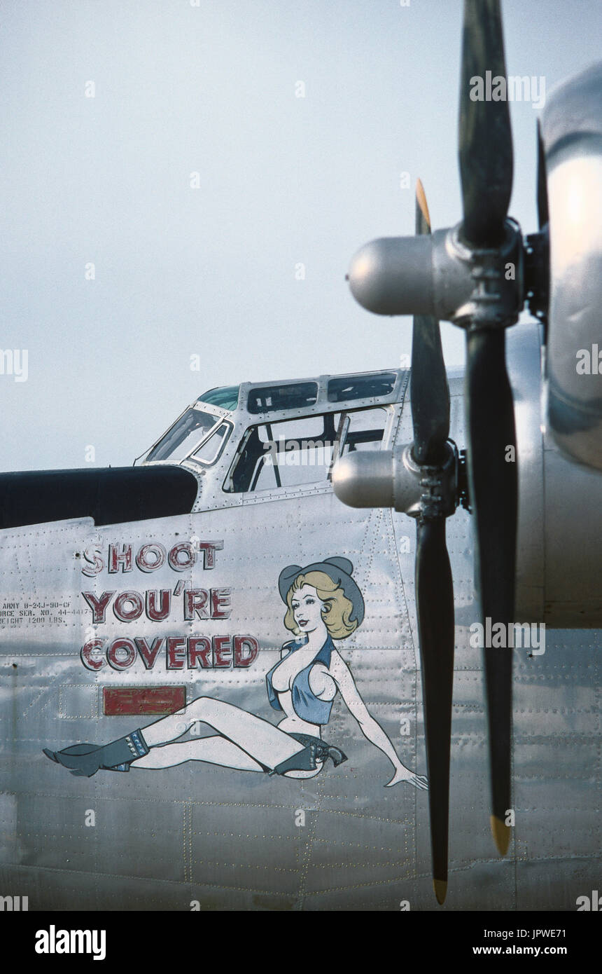 USAF Consolidated B-24J Liberator wearing nose art named 'Shoot you're Covered' with a naked woman cow girl Stock Photo