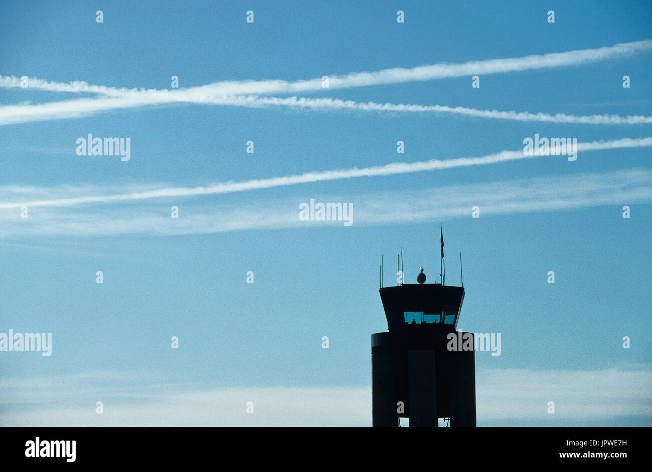 multiple airliners contrails over the air-traffic control-tower at Las Vegas International Stock Photo