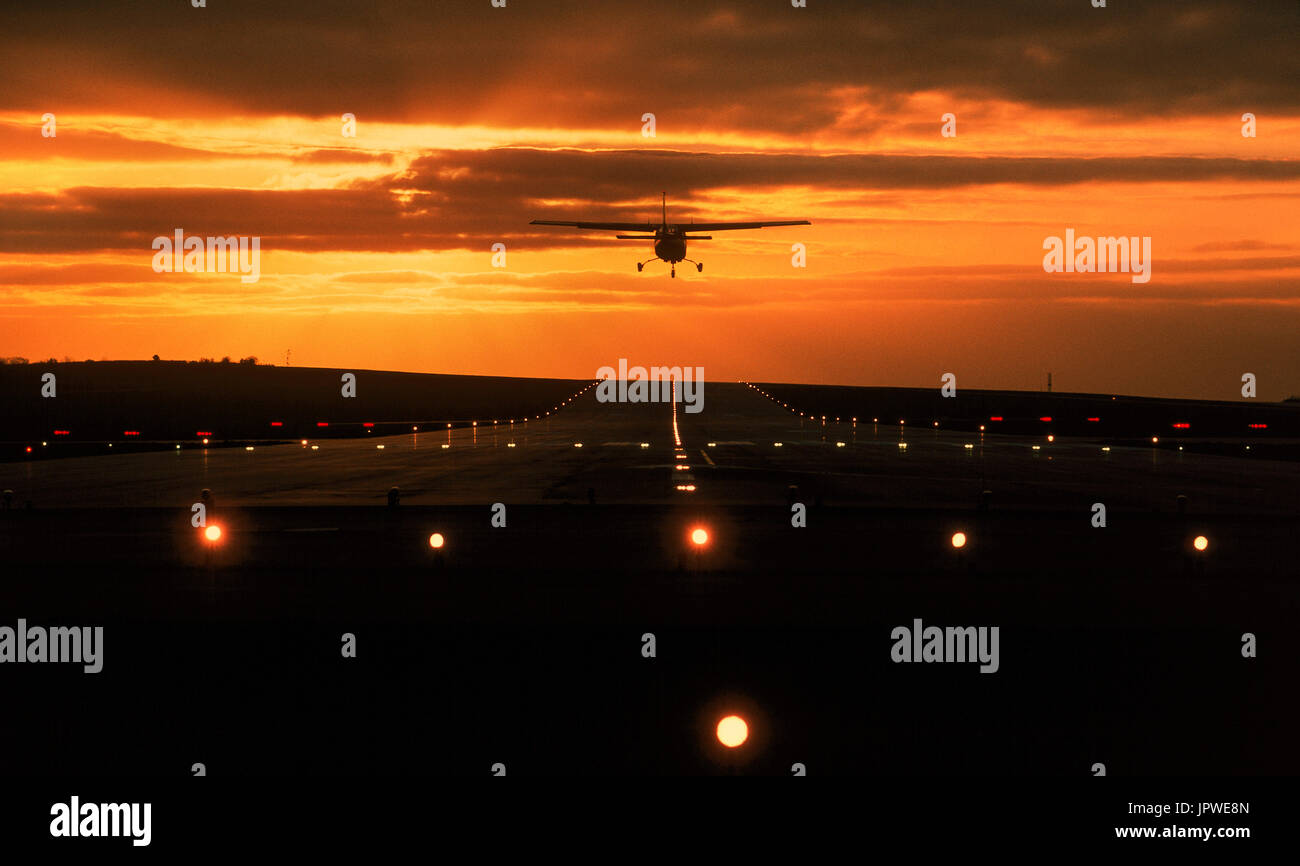 Cessna 177RG Cardinal RG landing on the runway at sunset with lights on Stock Photo Alamy