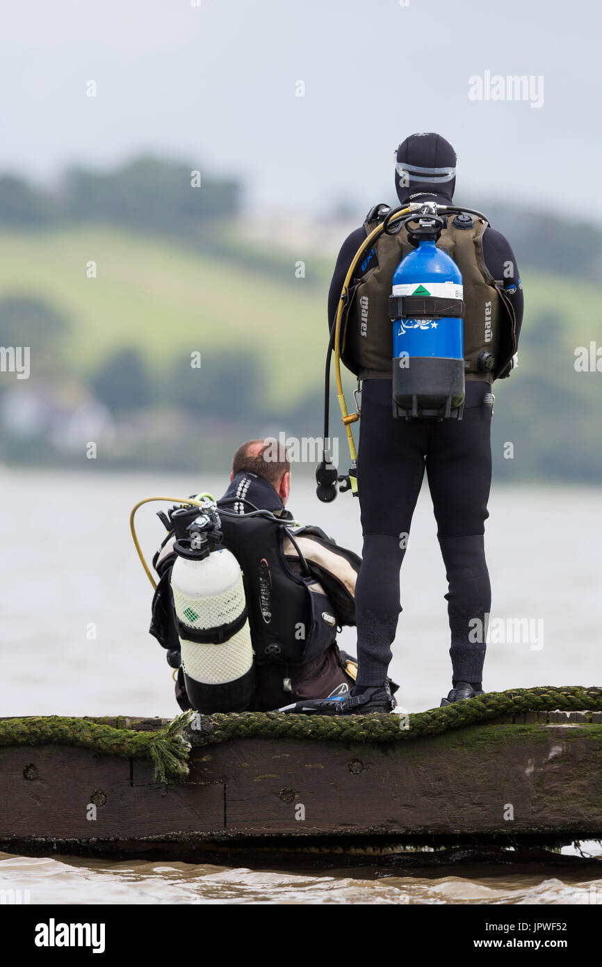 Two scuba divers prepare to enter the water Stock Photo Alamy