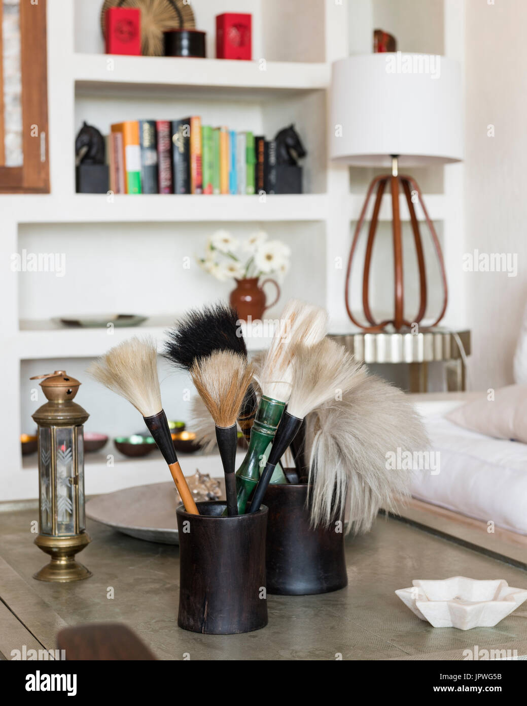 Paintbrushes on coffee table Stock Photo