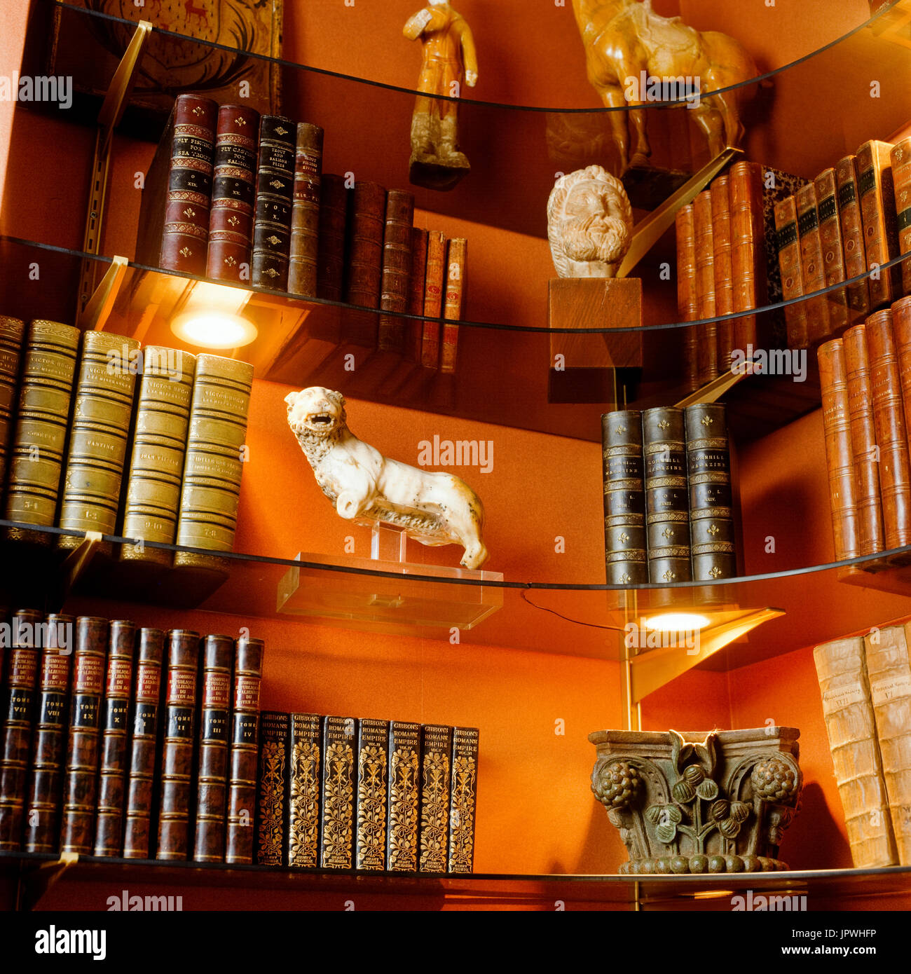 Bookshelf with sculptures Stock Photo Alamy