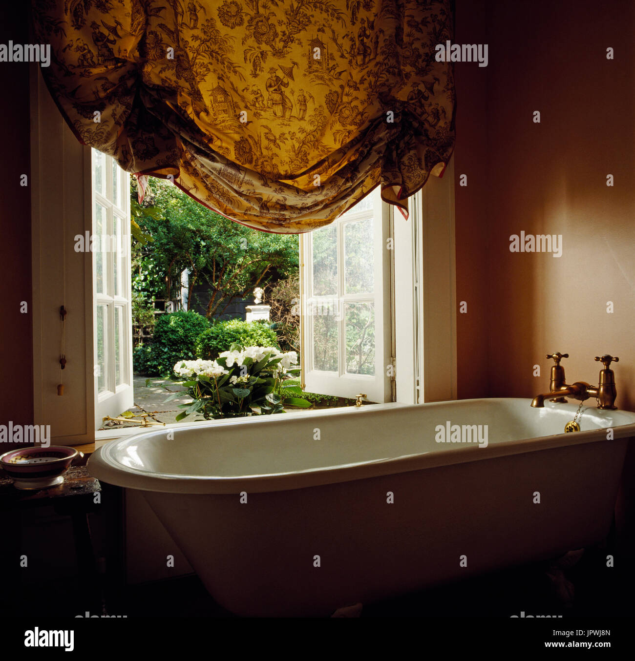 Freestanding bathtub by window Stock Photo Alamy