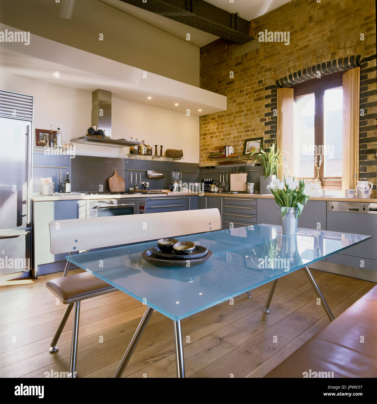 Modern style kitchen and dining table Stock Photo - Alamy