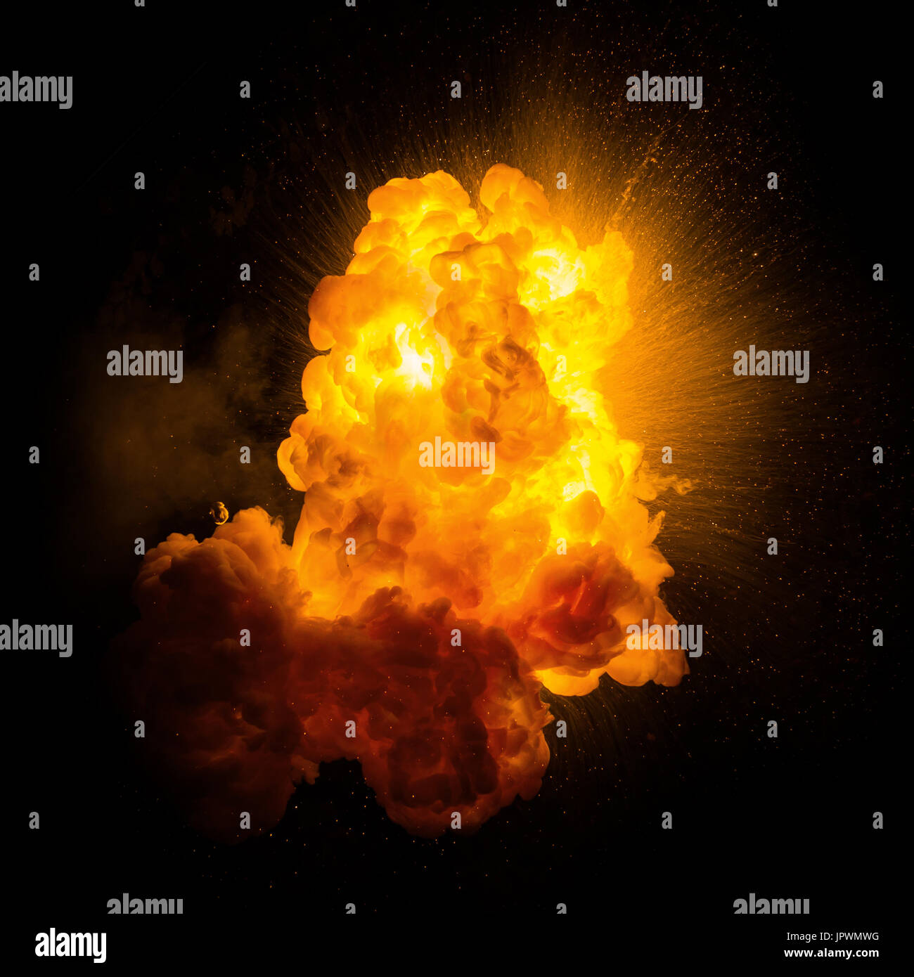 Realistic fiery explosion with sparks over a black background Stock Photo