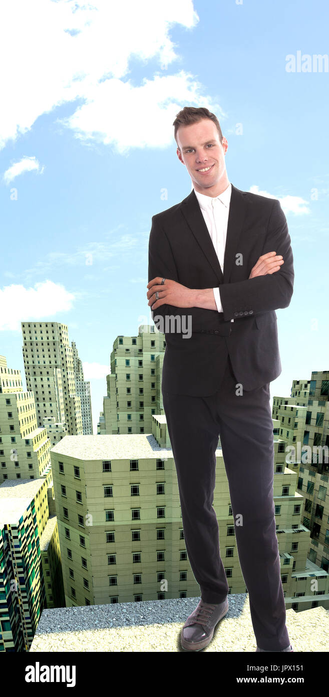 Young businessman on top of rendered building view Stock Photo