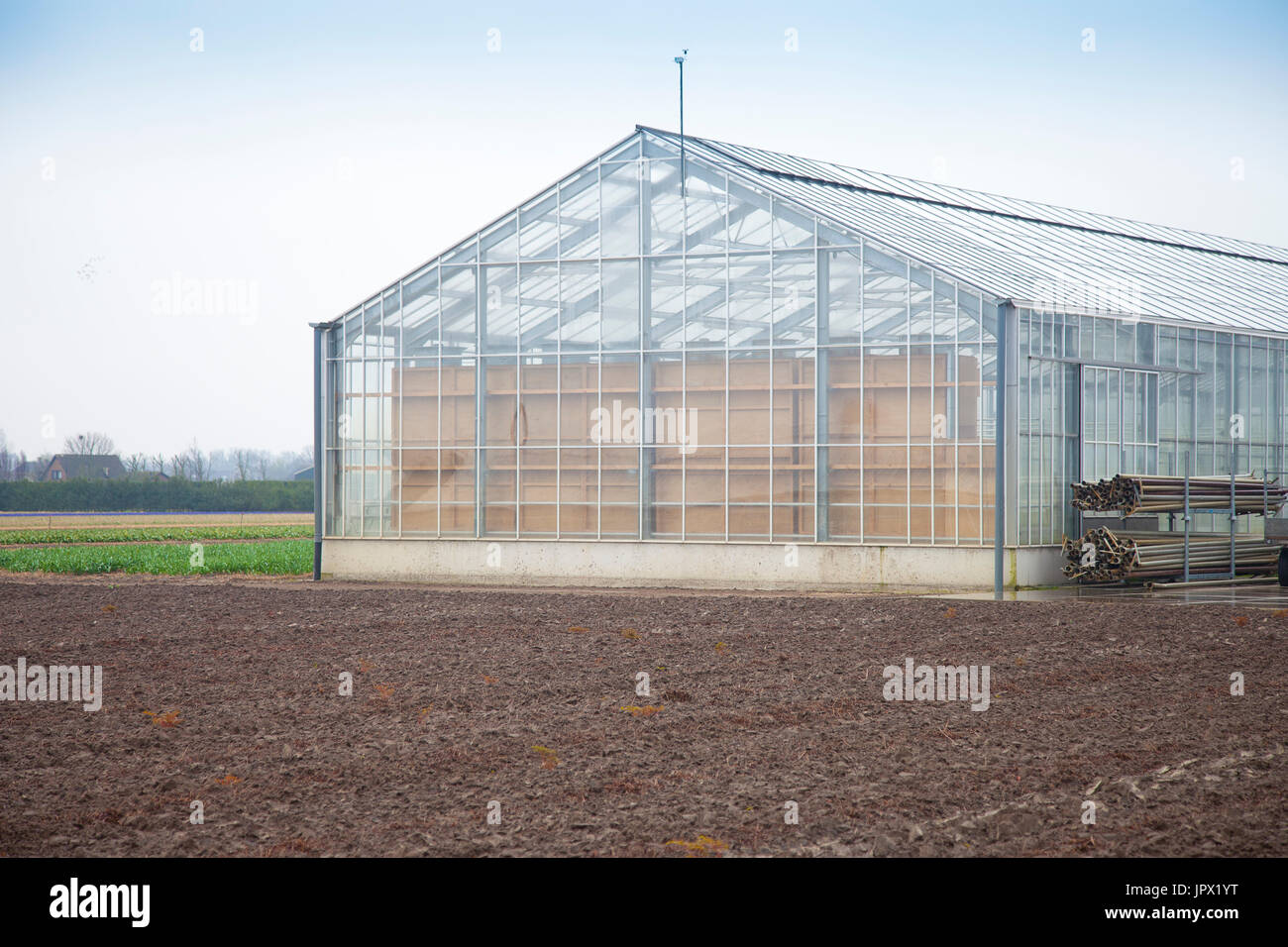 Glass house in agricultural landscape Stock Photo