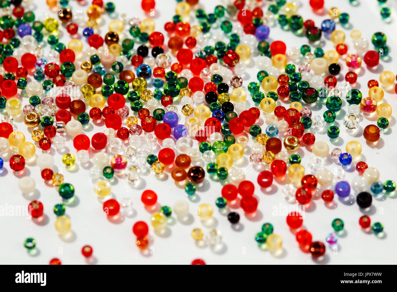 Colorful glass beads on white background, close up photo. Stock Photo