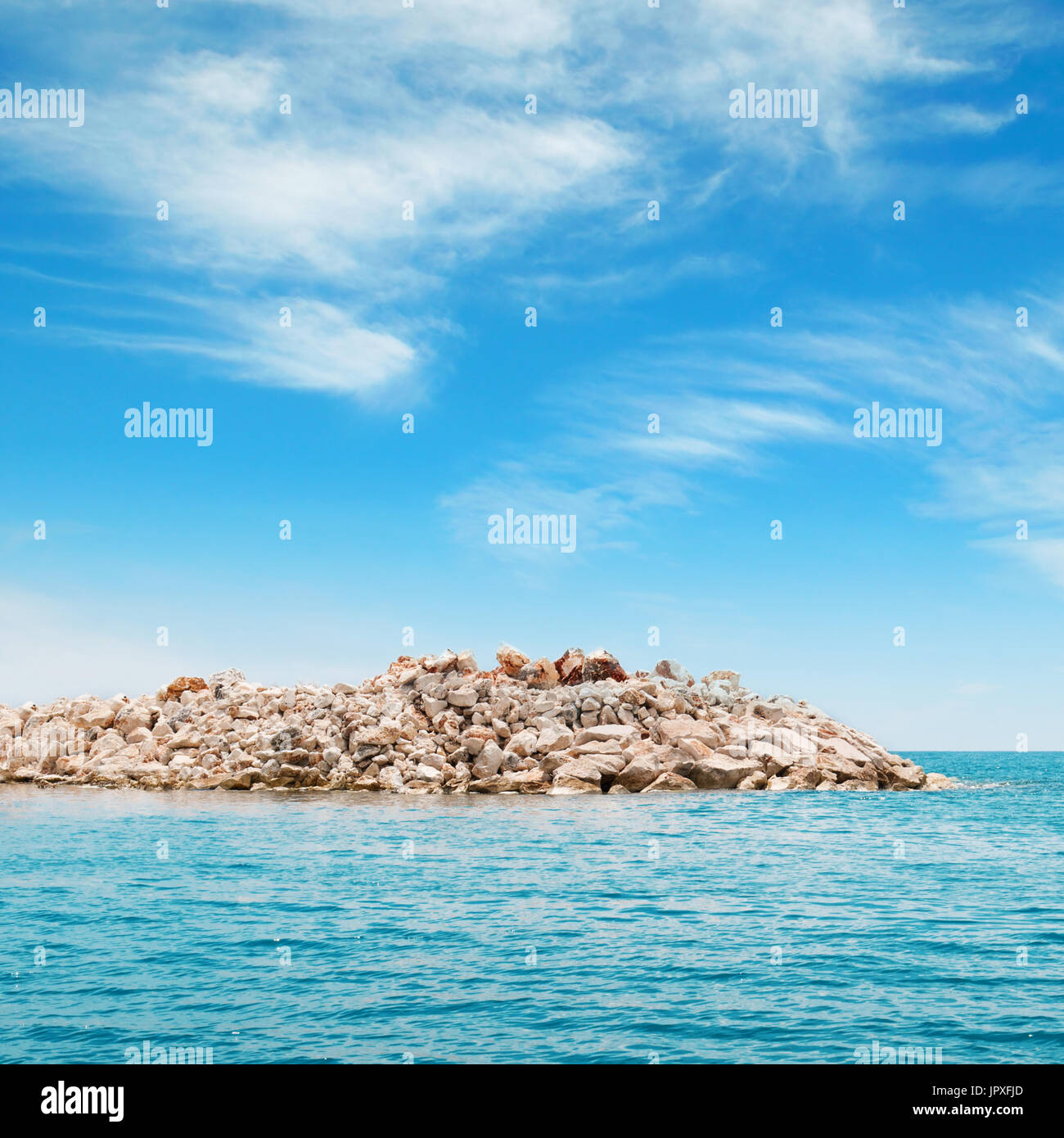 azure sea and the rocky island Stock Photo - Alamy