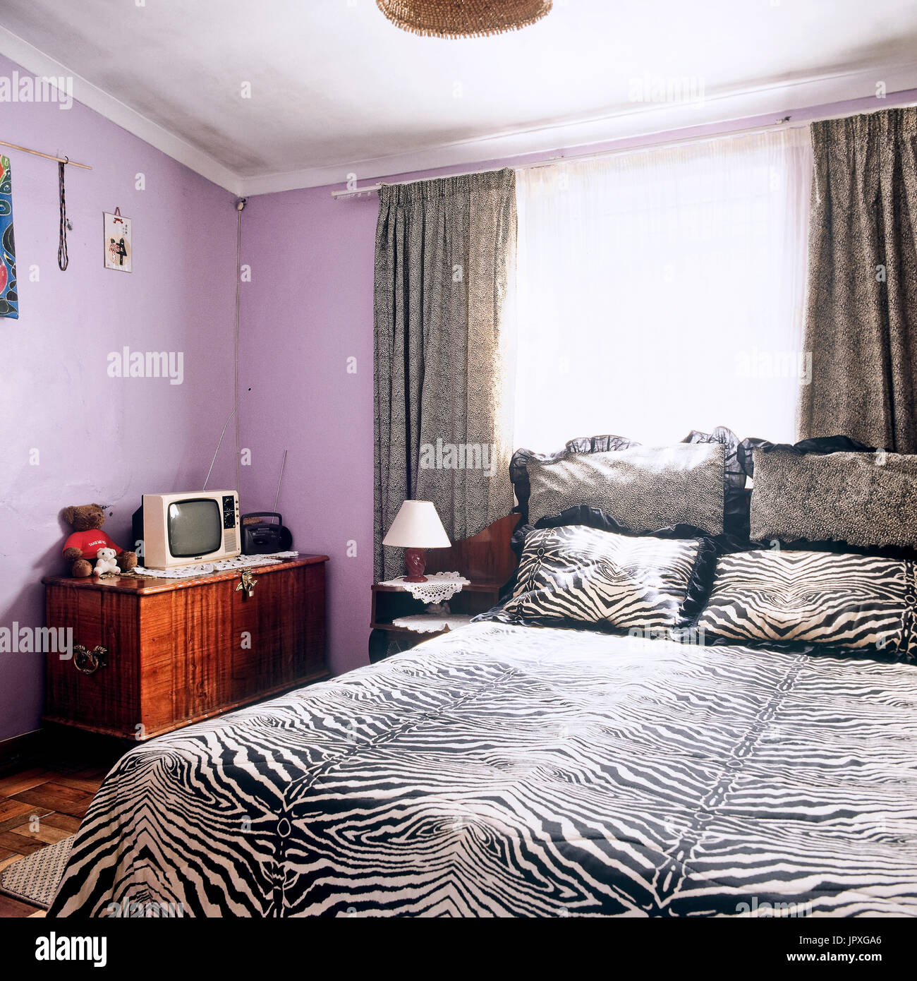 Bedroom with zebra skin pattern bedding Stock Photo