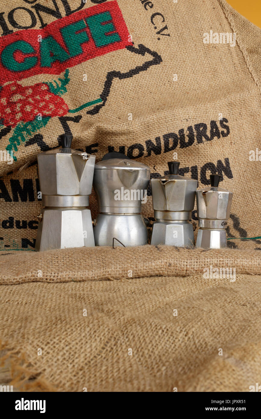 Tavigliano, Italy - August, 01, 2017: Four italian moka in vintage still life style, coffee jute bag in background. Stock Photo