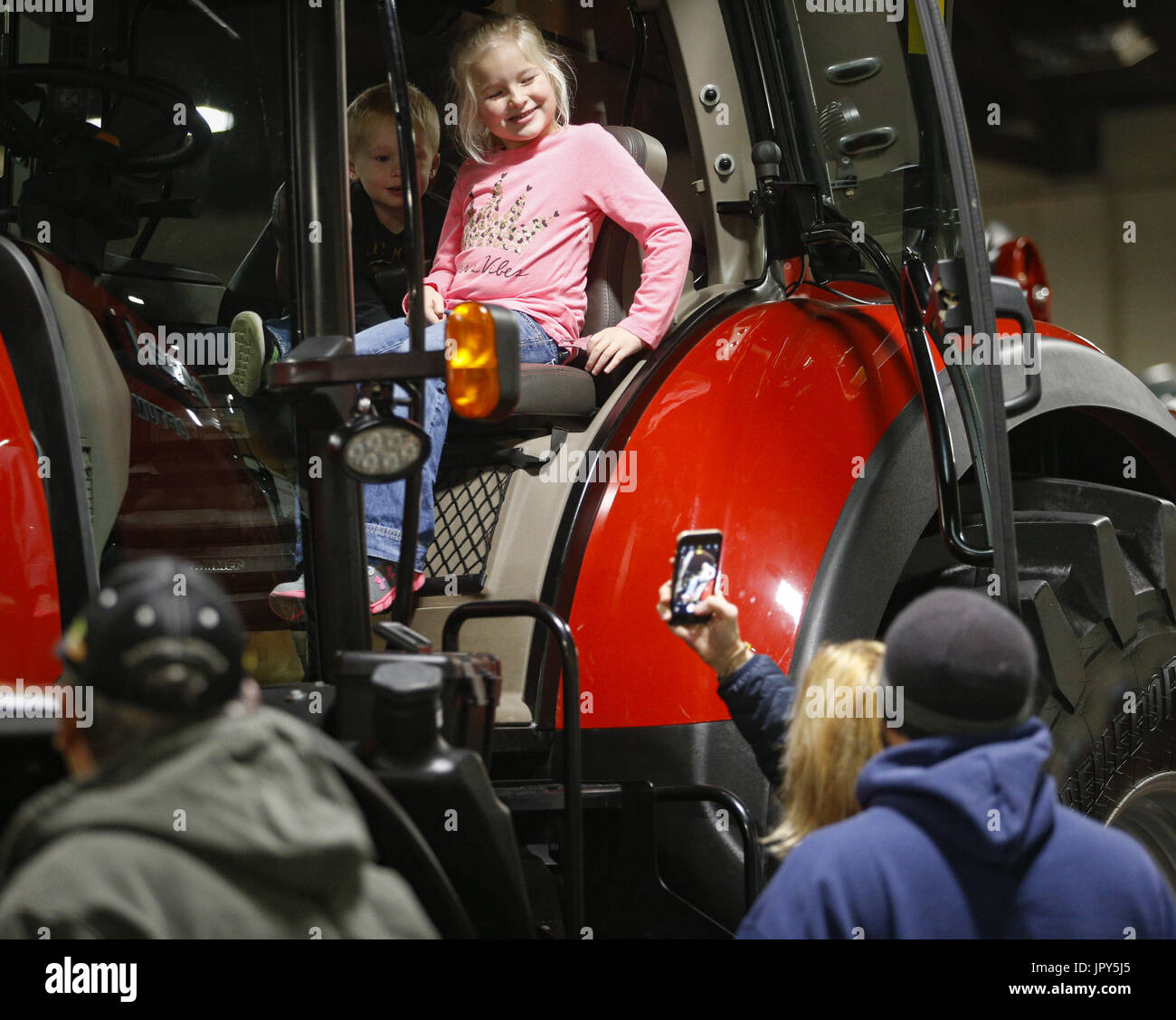 Rock Island, Iowa, USA. 15th Jan, 2017. Kylee Fischer, 5, of Grand Mound poses with her brother, Dylan, 3, for a photo on a Case tractor at the Quad-City Conservation Alliance Expo Center in Rock Island on Sunday, January 15, 2017. The 26th annual Quad-Cities Farm Show spans from Jan. 15-17 featuring over 200 agriculture companies and a variety of available products. Credit: Andy Abeyta/Quad-City Times/ZUMA Wire/Alamy Live News Stock Photo
