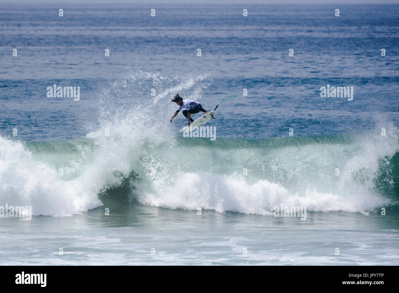 Huntington Beach, USA. 02 August, 2017. Heitor Alves (BRA) lands one of multiple airs during his round 2 heat of the men's QS competition at the 2017 VANS US Open of Surfing. Credit: Benjamin Ginsberg/Alamy Live News. Stock Photo