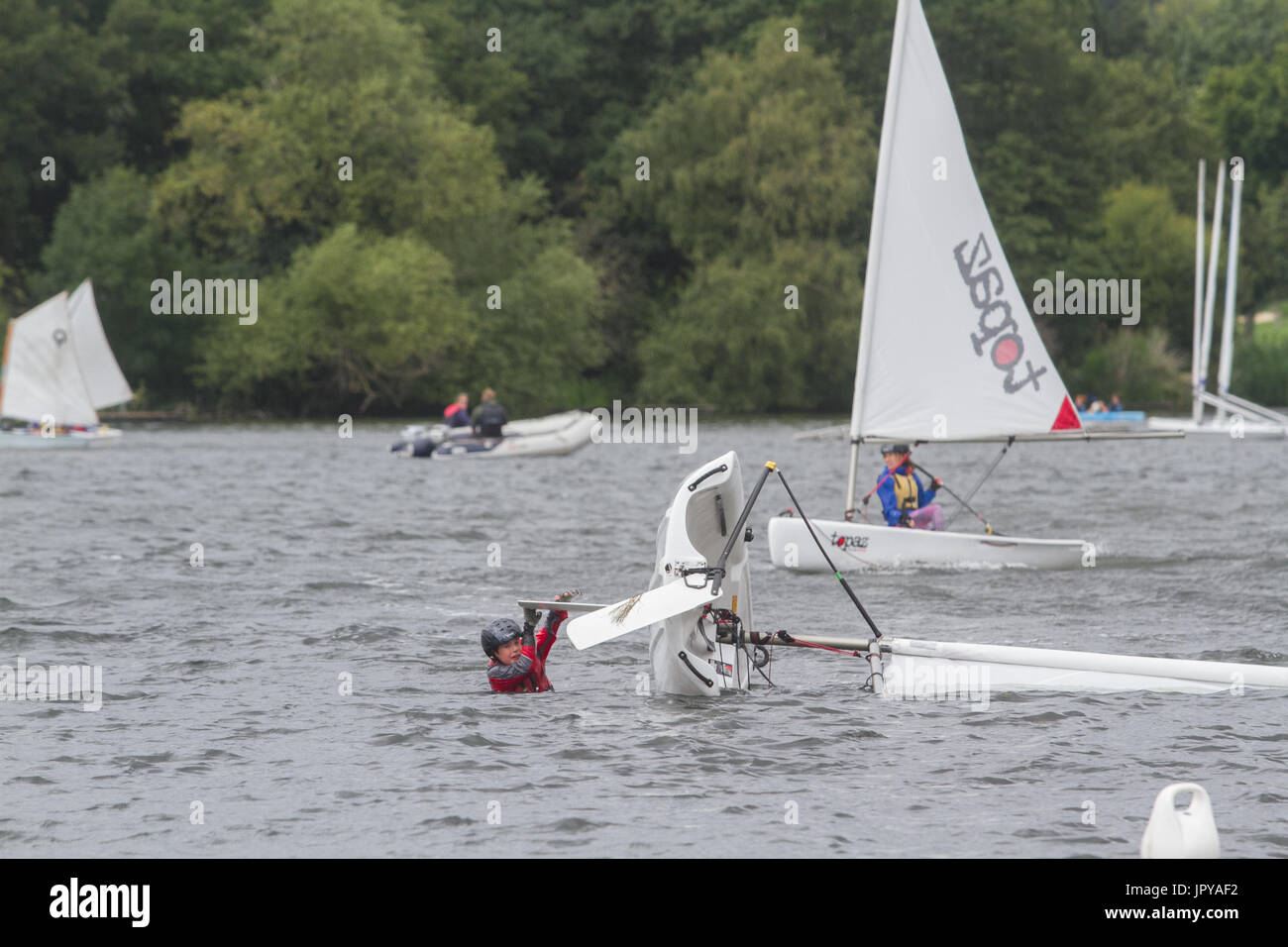 London UK. 3rd Aug, 2017. A sailing Dinghy capsizes from the high winds