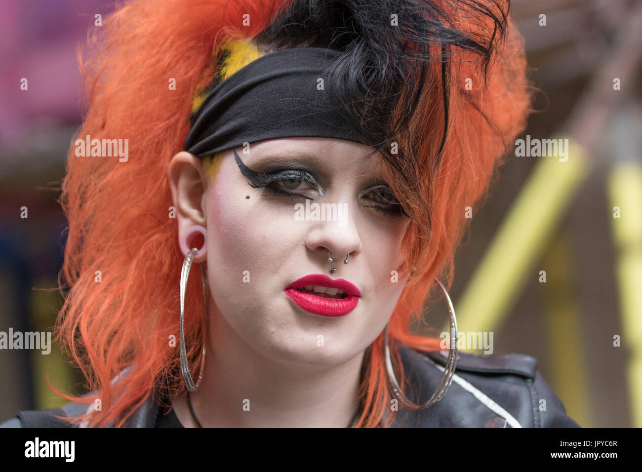 Ear stretching, lobe 'gauging' in Blackpool, Lancashire, UK. Iska with  pierced ears, plastic inserts and wearing large ear rings, from Birminham.  The Rebellion Festival world's largest punk festival begins as thousands of