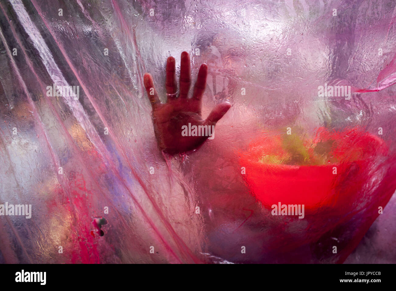 Dhaka, Bangladesh. 3rd Aug, 2017. People use a plastic sheet to protect