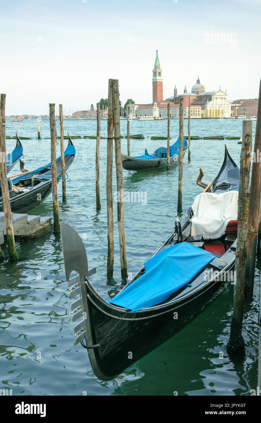 View through the pillars and gondolas from St. Mark's Square to San Giorgio Maggiore church in Venice, Italy Stock Photo