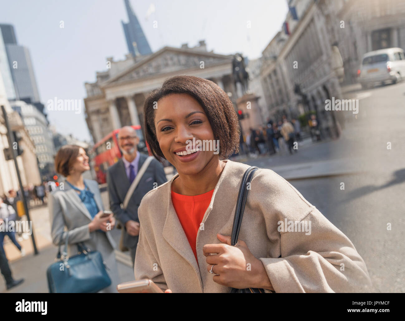 Portrait smiling, confident businesswoman on urban city street, London, UK Stock Photo