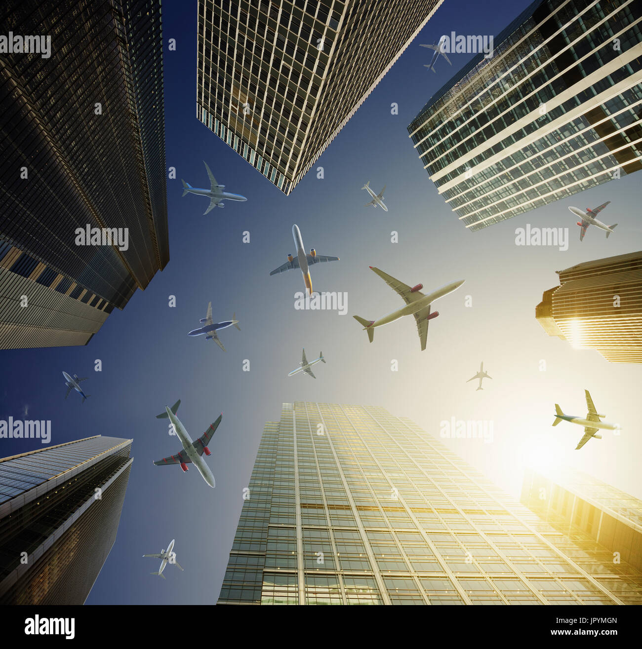 Airplanes in blue sky above highrise buildings, travel concept Stock Photo