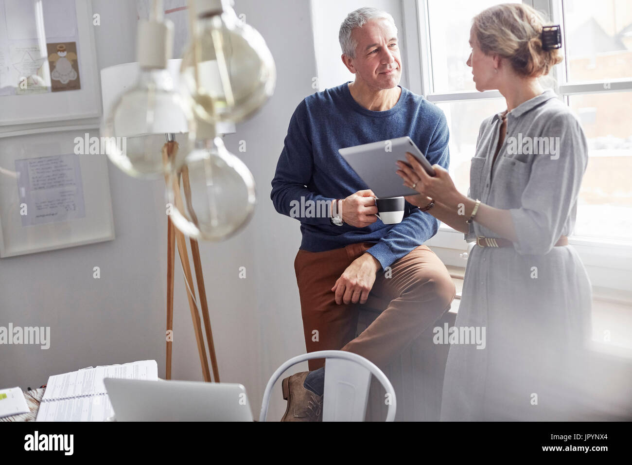 Business people drinking coffee and using digital tablet in office meeting Stock Photo