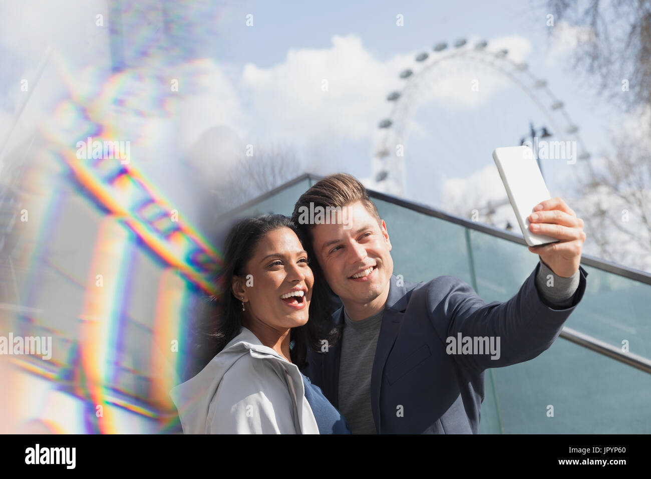 Smiling couple tourists taking selfie near Millennium Wheel, London, UK Stock Photo