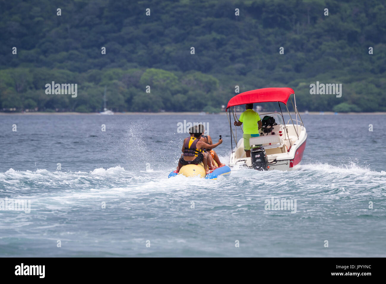 Guanacaste, Costa Rica- July 25: Family enjoying a banana boat ride in ...