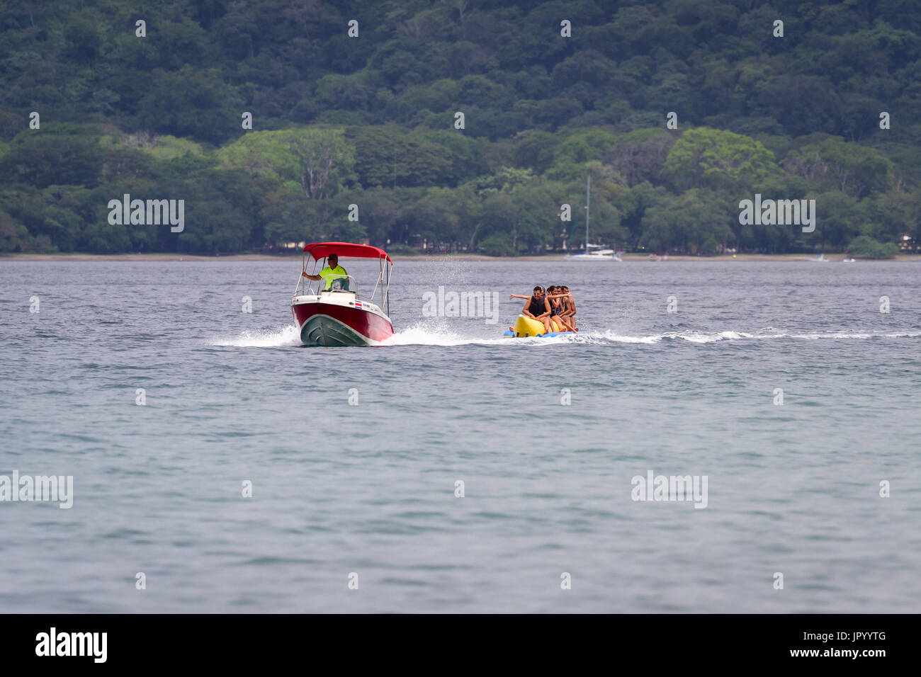 Guanacaste, Costa Rica- July 25: Family enjoying a banana boat ride in ...