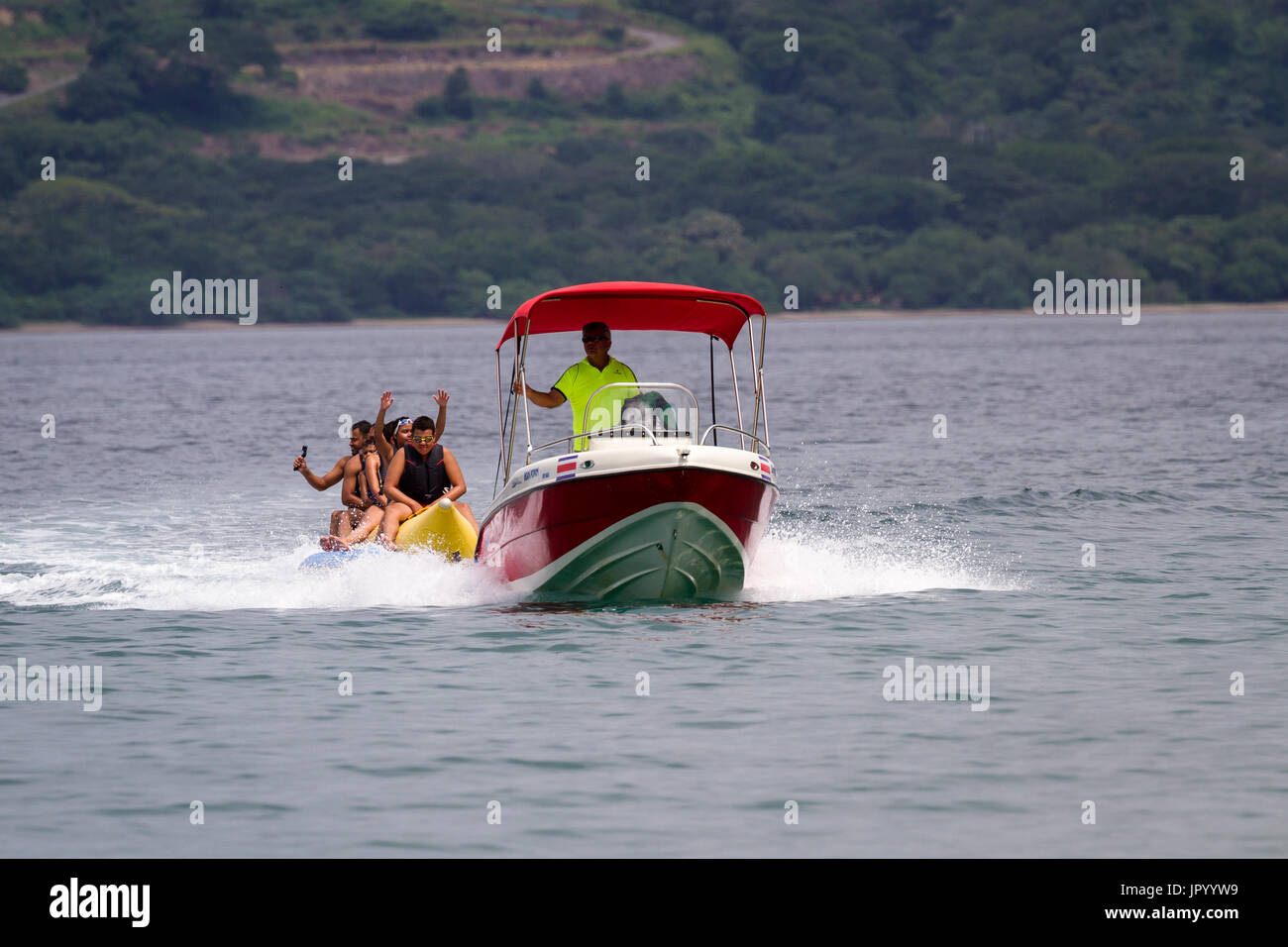 Guanacaste, Costa Rica- July 25: Family enjoying a banana boat ride in ...
