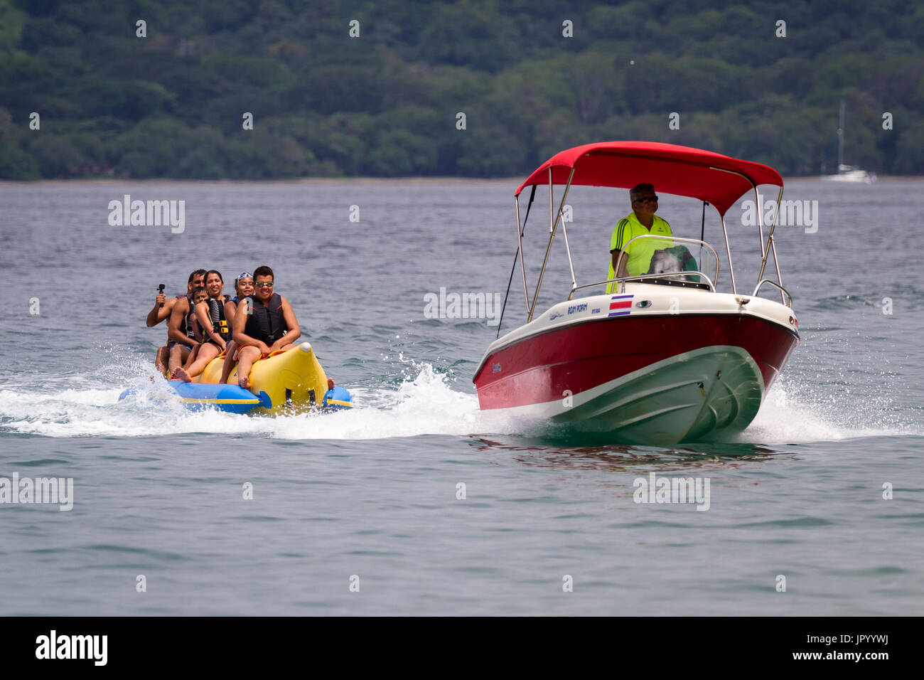 Guanacaste, Costa Rica- July 25: Family enjoying a banana boat ride in ...