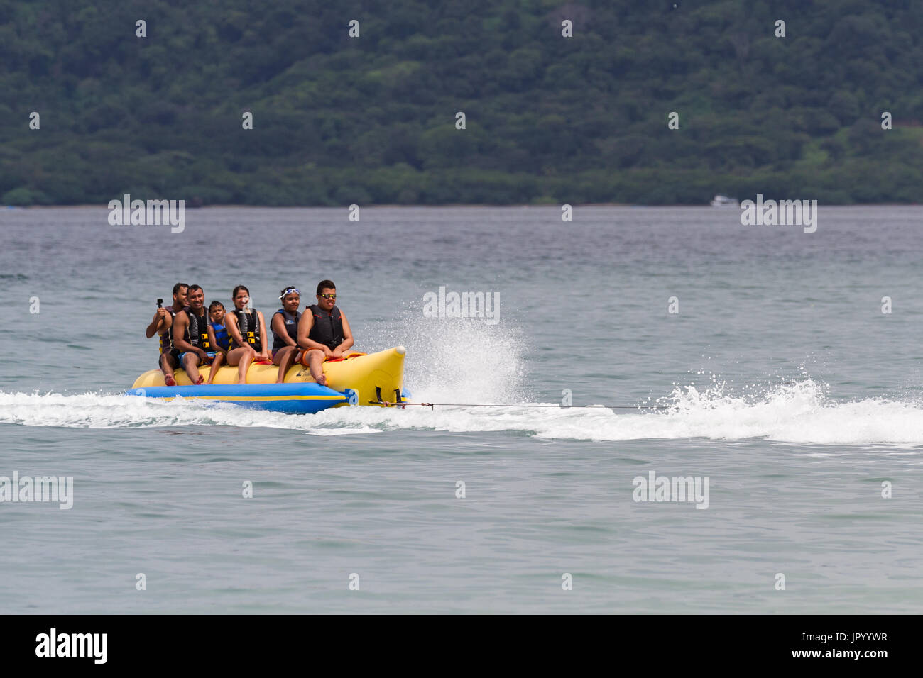 Guanacaste, Costa Rica- July 25: Family enjoying a banana boat ride in ...