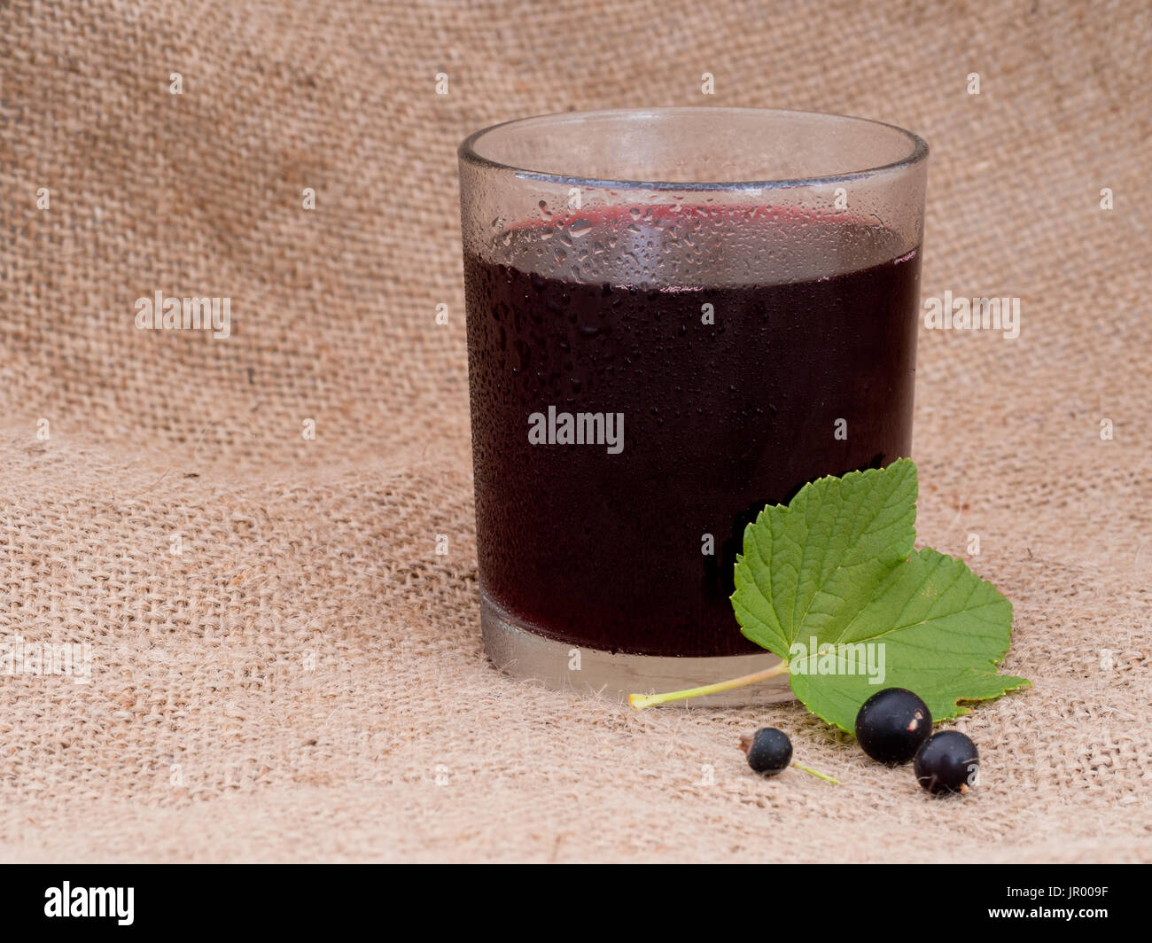 Blackcurrant drink on hessian Stock Photo Alamy