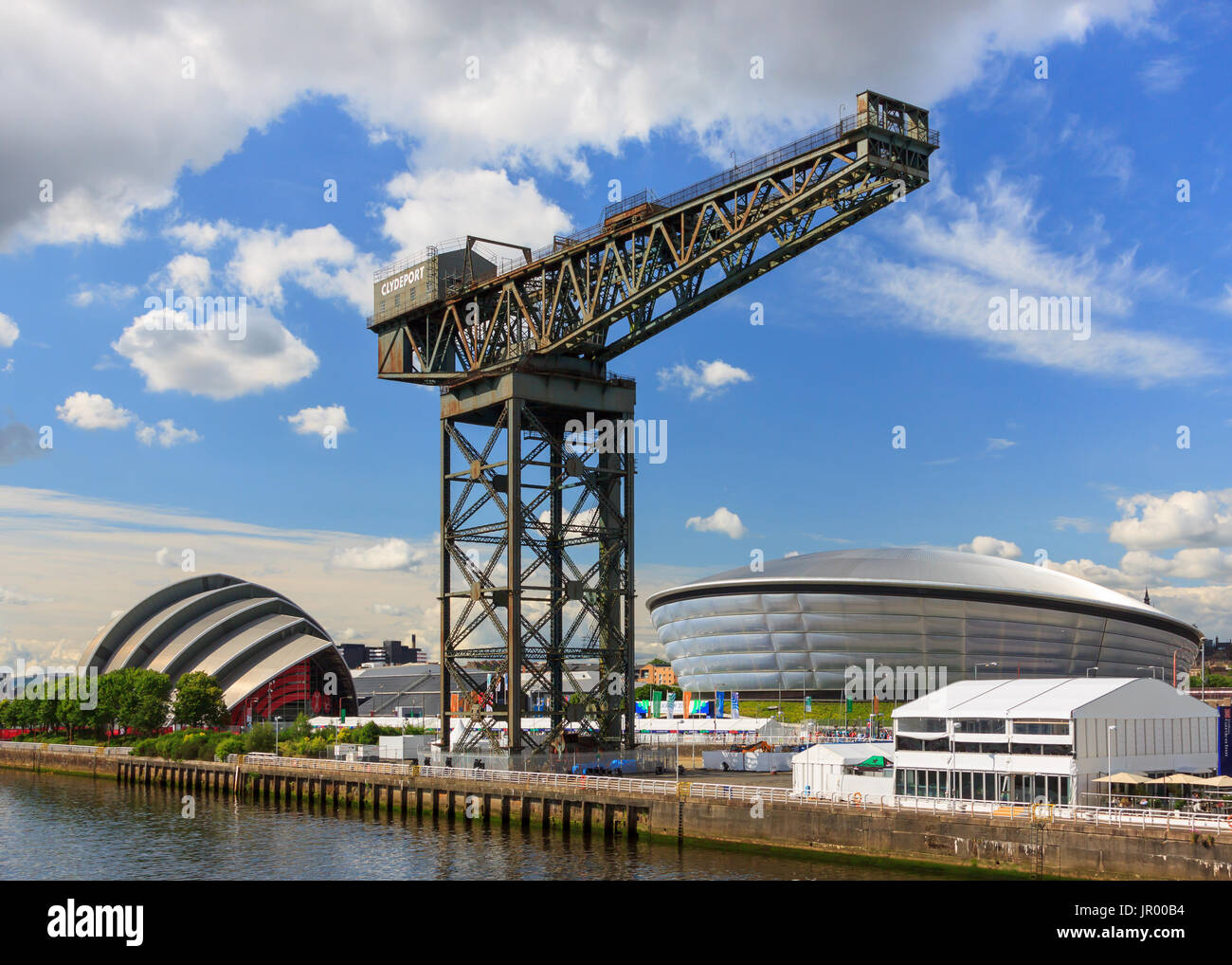 The Finnieston Crane on the banks of the River Clyde in Glasgow, Scotland.  In the background is the SSE Hydro arena and the Clyde auditorium. Stock Photo