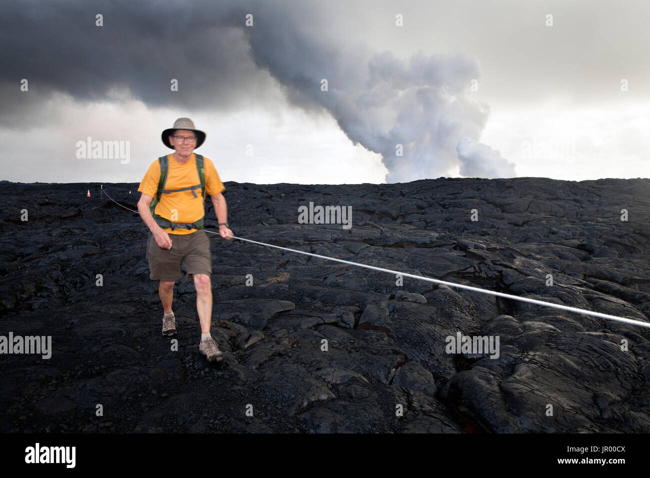 HI00290-00...HAWAI'I - Hiker, Greg Vaughn,  walking across the Pu'u O'o lava field in Hawai'i Volcanoes National Park on the island of Hawai'i. (MR# V Stock Photo