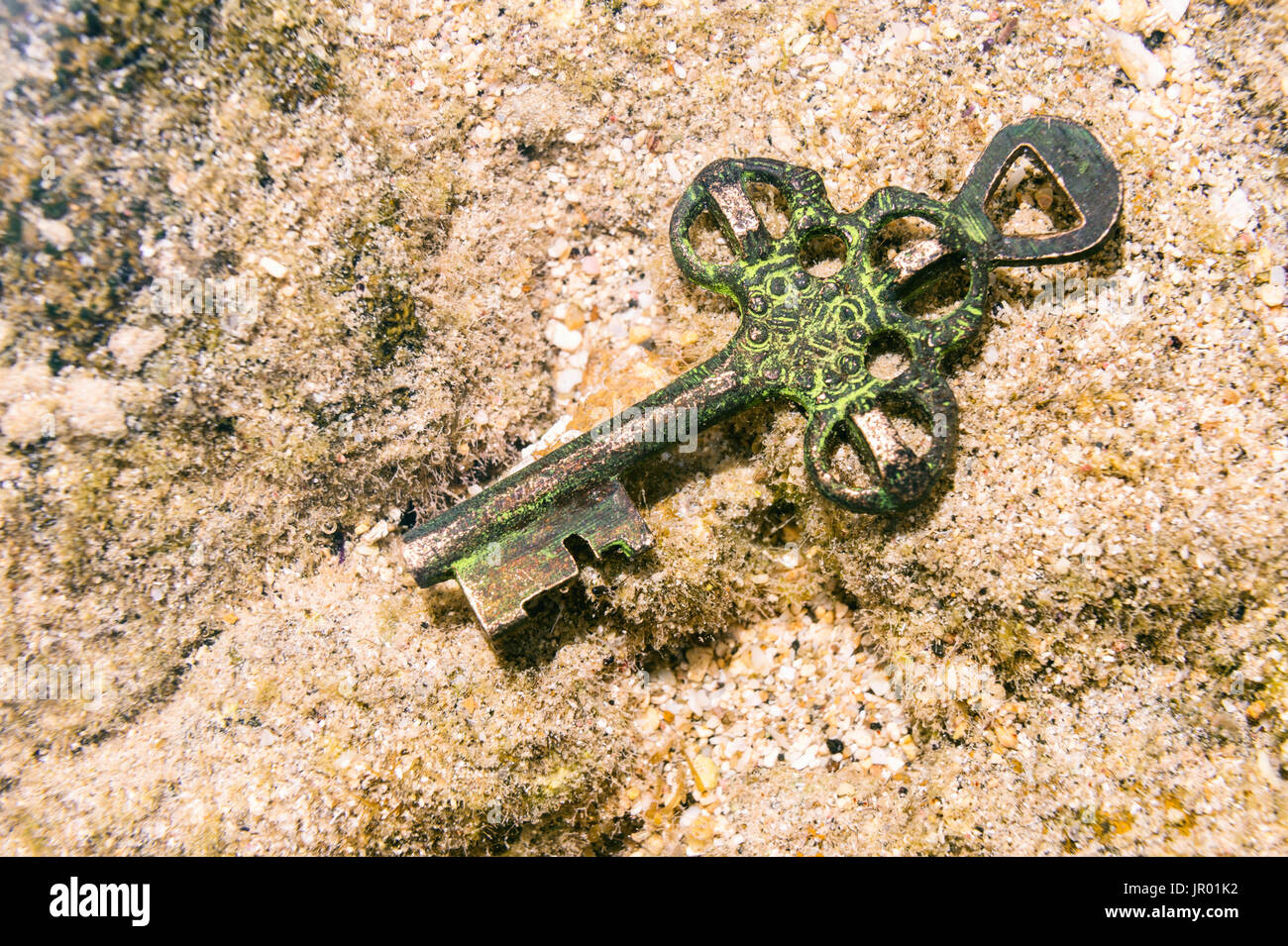 Treasure key lost at the bottom of the sea. Opportunity or Mystery concept. Stock Photo