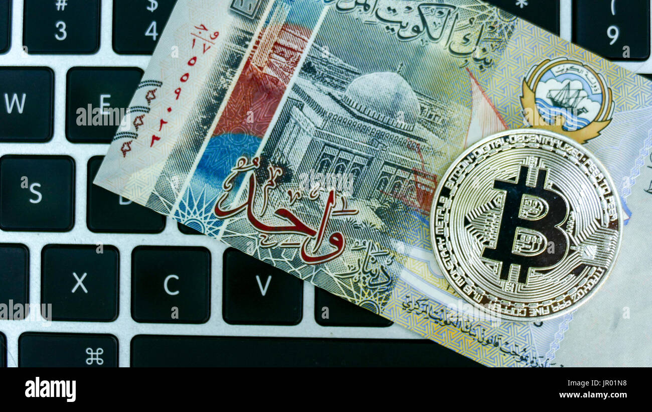 Bitcoin on Kuwait Dinar banknote. Electronic money exchange concept