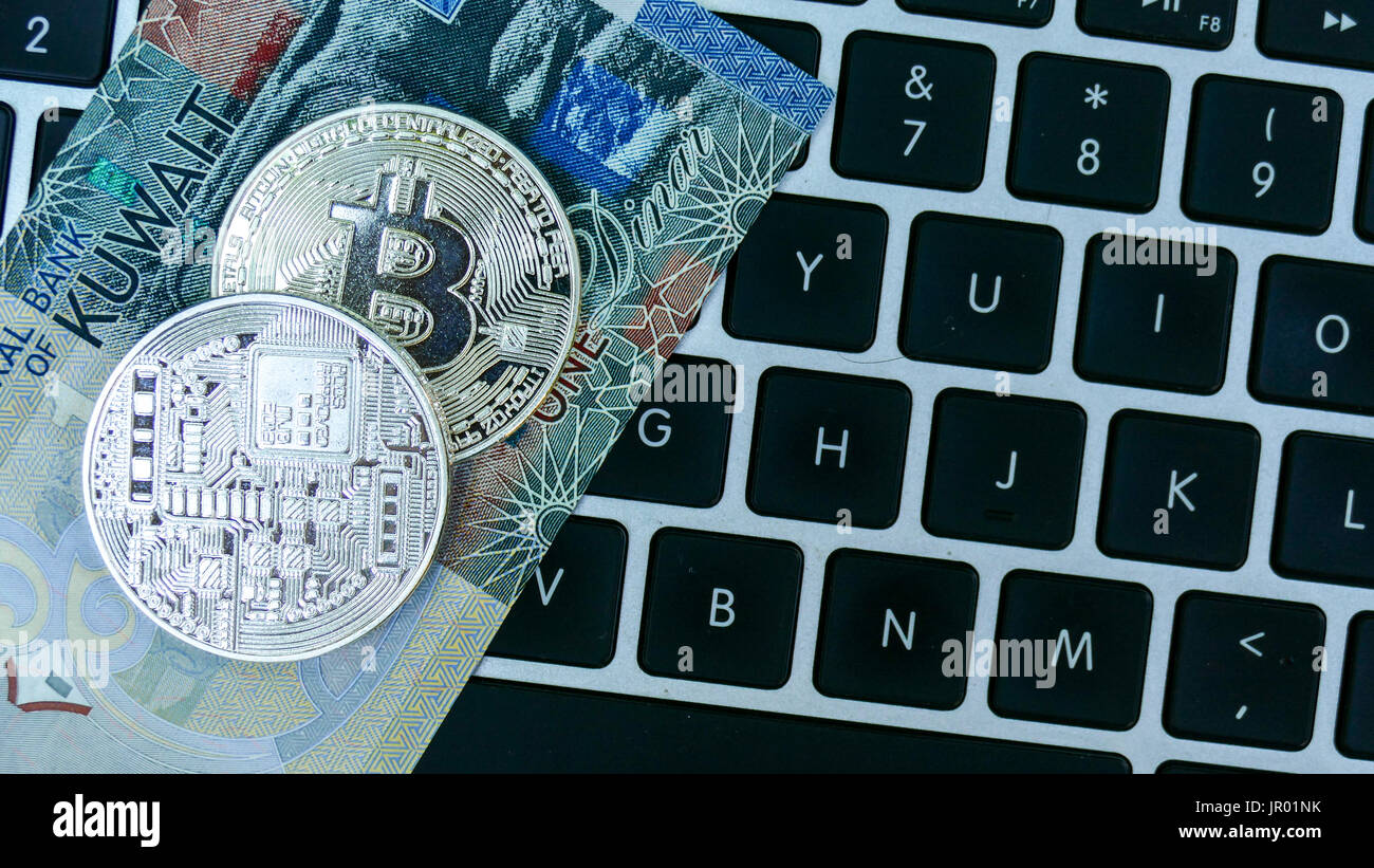 Bitcoin on Kuwait Dinar banknote. Electronic money exchange concept