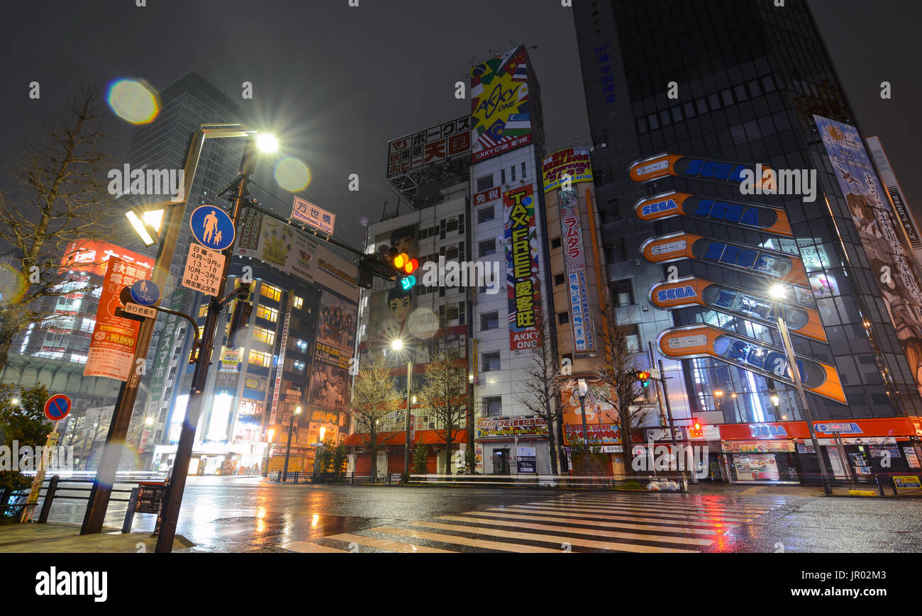 TOKYO, JAPAN - APRIL 8, 2017 - Rain glitters in the night lights of Akihabara, Tokyo's famous electronics shopping district popular with geeks and gam Stock Photo