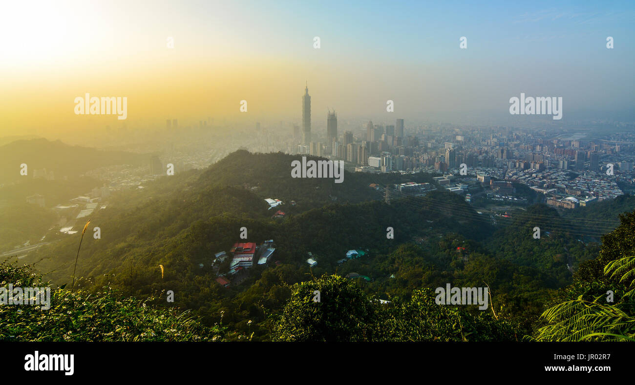 Sunset cityscape of Taipei, Taiwan as seen from a mountaintop overlooking the metropolitan city Stock Photo
