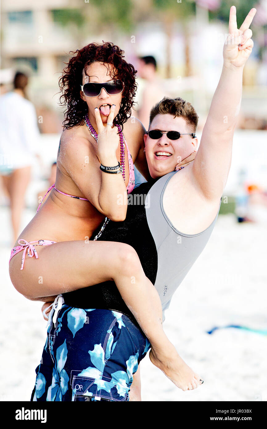 Amusing young couple expressing their enthusiasm for being at Panama City Beach during spring break. Stock Photo