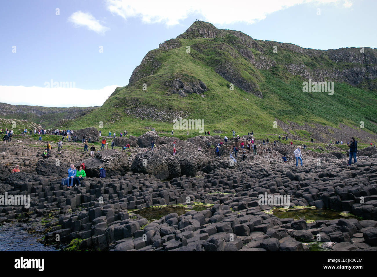 Tourists discover Northern Ireland Giants Causeway Coastline and its  famous basalt columns natural wonder and world heritage site located in Antrim Stock Photo